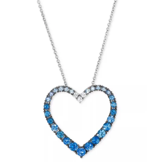 A heart-shaped necklace with a gradient of blue gemstones set in a silver chain.
