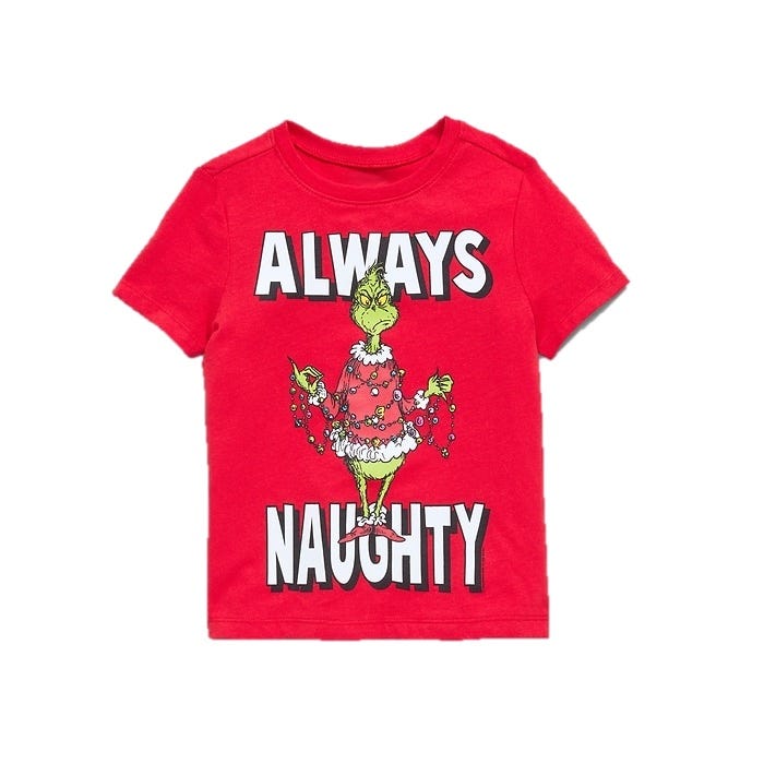 A red T-shirt featuring the character Grinch in a Santa outfit with Christmas lights, accompanied by the text \“Always Naughty.\“