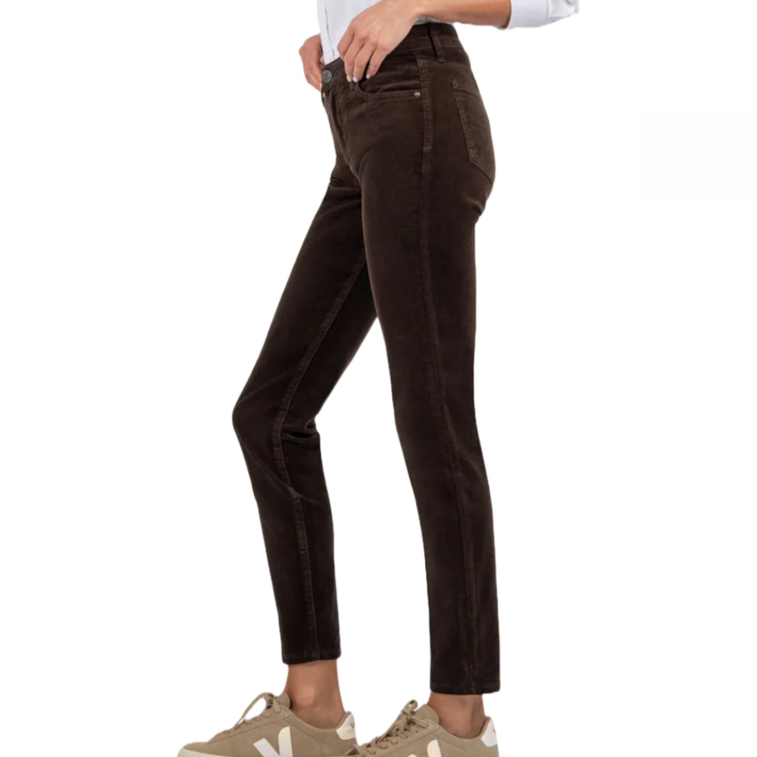 KUT from the Kloth corduroy pants are brown, high-waisted, and feature a slim fit. They end at the ankle and are paired with beige sneakers in the image shown.