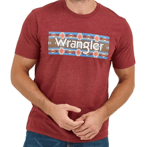 A person wears a maroon Wrangler T-shirt featuring a southwestern pattern in the center. The shirt is paired with blue jeans.