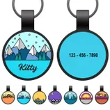 Round pet tag featuring mountain designs with \“Kitty\“ and a customizable phone number. Below are additional designs, including sunset, galaxy, forest, and beach themes.