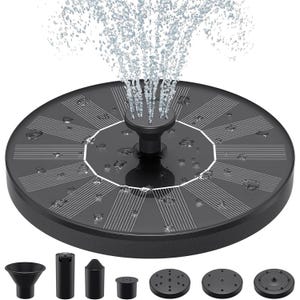 Round solar-powered fountain with a central water spray feature and multiple nozzle attachments for different spray patterns. The surface is covered with solar panels and is sprinkled with water droplets.