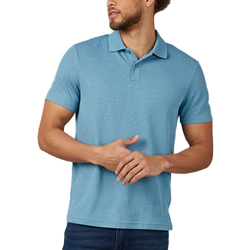 A man wears a light blue short-sleeve polo shirt and dark jeans.