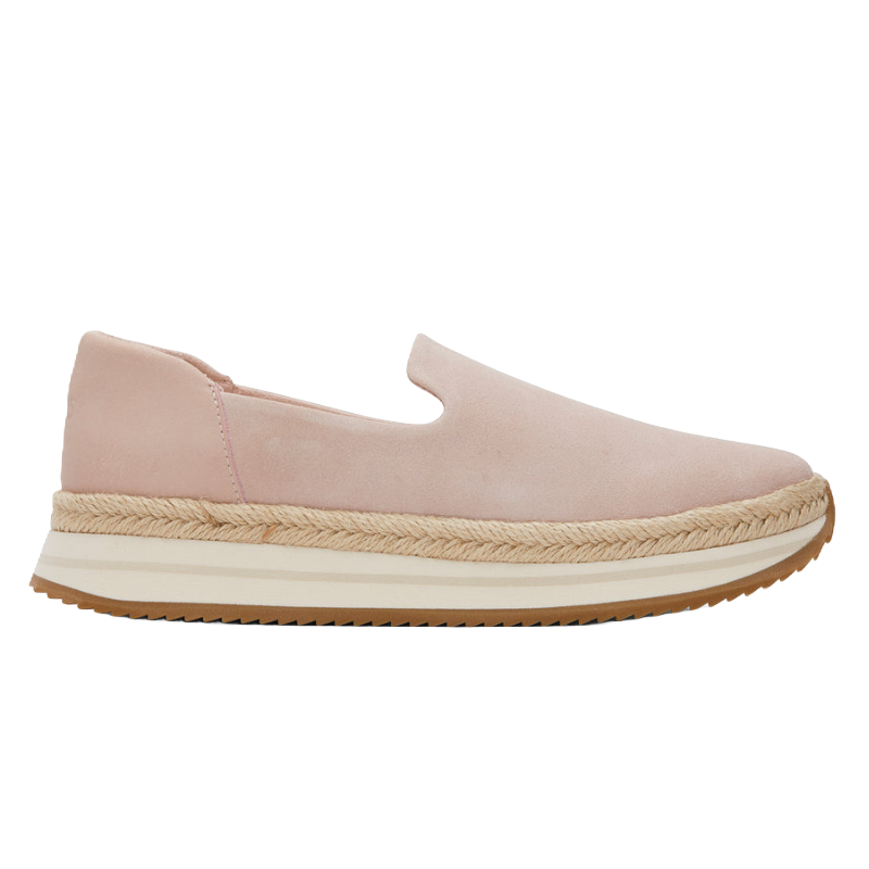 A light pink slip-on shoe with a suede-like texture, featuring a woven espadrille-style platform and a white and brown rubber sole.