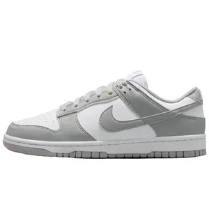A low-top sneaker in white and grey tones with a distinctive logo on the side, featuring a lace-up design and perforated toe box for breathability.