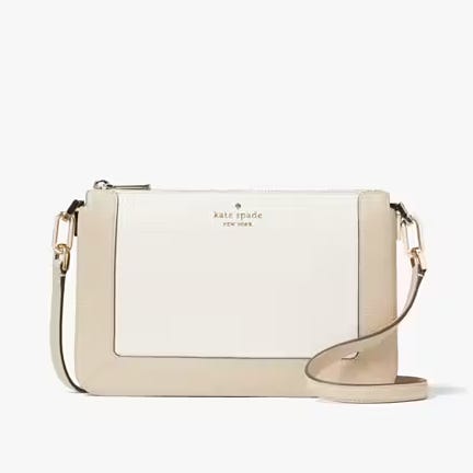 A beige crossbody bag with an adjustable strap and gold-tone hardware.