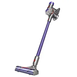 Cordless stick vacuum with a purple wand, featuring multiple attachments including a crevice tool, combination tool, mini motorized tool, soft dusting brush, and a flexible hose.