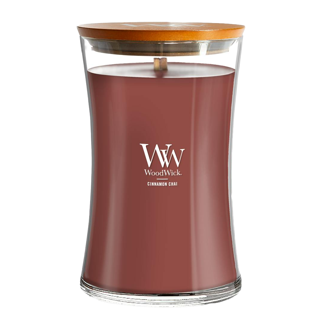 WoodWick candle with a wooden lid, labeled \“Cinnamon Chai,\“ featuring a crackling wick for a cozy sound.