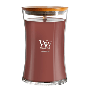WoodWick candle with a wooden lid, labeled \“Cinnamon Chai,\“ featuring a crackling wick for a cozy sound.