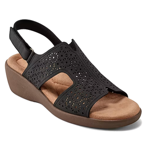 Black sandal with a cut-out, perforated design, featuring a slingback strap and cushioned footbed on a low wedge heel.