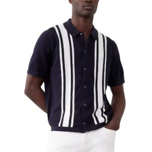 A navy short-sleeve polo shirt featuring vertical white stripes and a button-down front, paired with white pants.