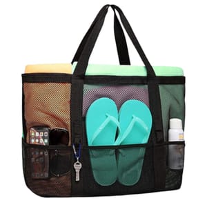 A large black mesh beach bag containing a pastel towel, turquoise flip-flops, sunscreen, a smartphone, sunglasses, and keys. The bag has multiple compartments for organization.