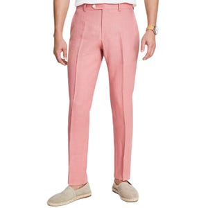 A person is wearing pink tailored pants paired with light-colored espadrilles and a watch.