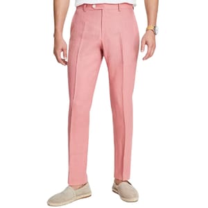 A person is wearing pink tailored pants paired with light-colored espadrilles and a watch.