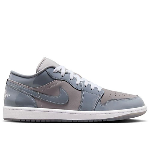 Low-top sneaker in shades of gray with white laces, featuring a prominent Nike Swoosh logo on the side and a white sole.