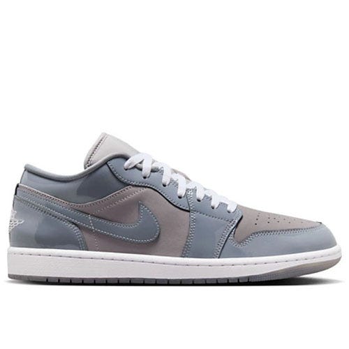 Low-top sneaker in shades of gray with white laces, featuring a prominent Nike Swoosh logo on the side and a white sole.