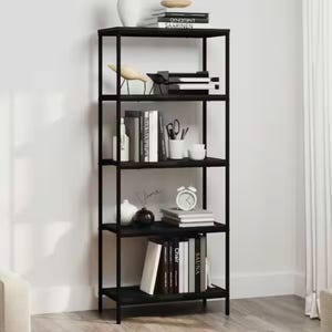 A black five-tier bookshelf with assorted books, decorative items, and stationery.