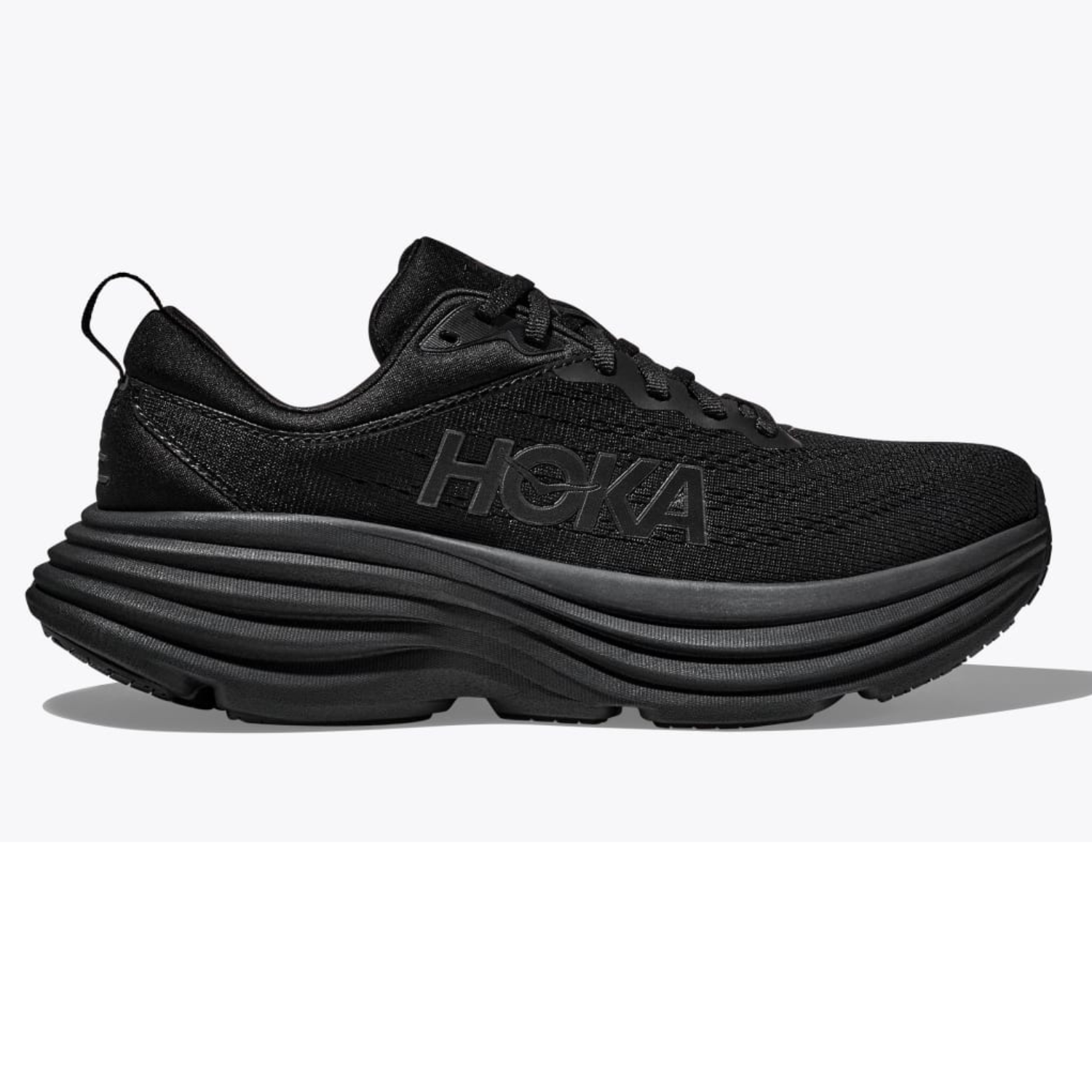 Hoka Men's Bondi Shoes are all-black running shoes with a thick, cushioned sole and a mesh upper for comfort. They feature the Hoka logo on the side and have a design suited for high-impact activities.