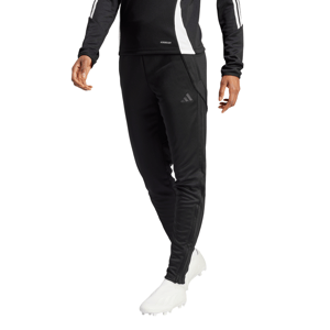 Black Adidas sportswear featuring three stripes on the sleeves and pants, paired with white athletic shoes.