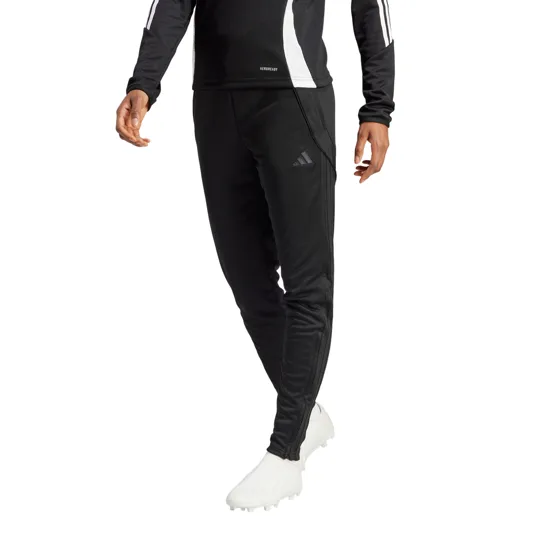 Black Adidas sportswear featuring three stripes on the sleeves and pants, paired with white athletic shoes.
