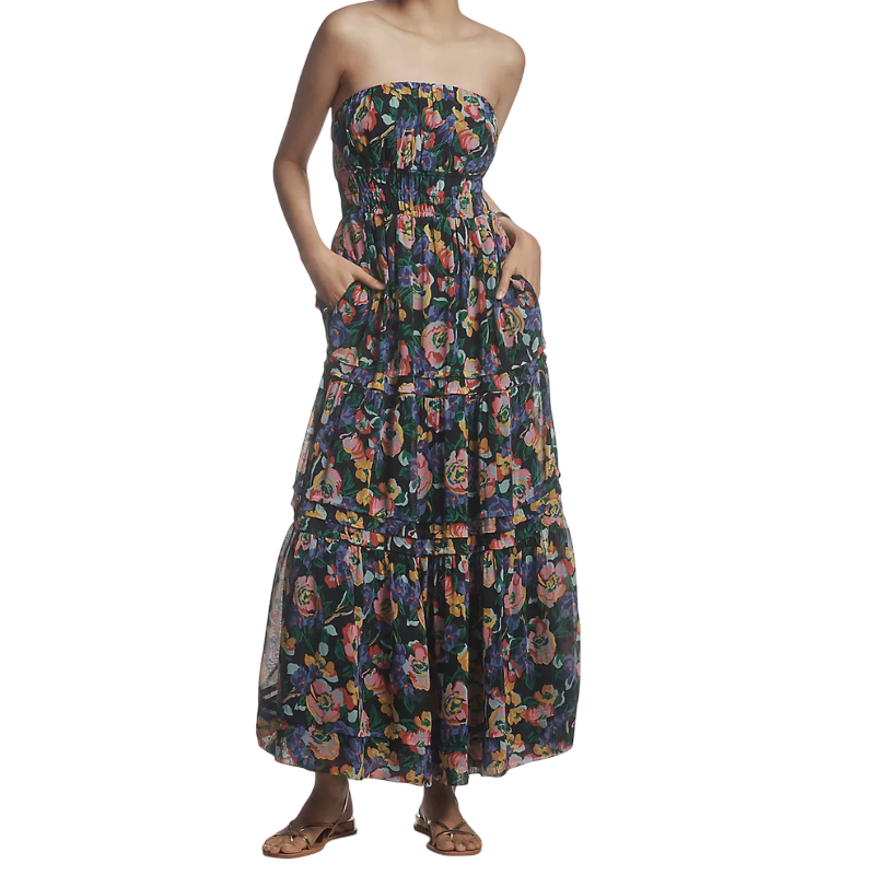Strapless floral maxi dress with a smocked bodice and tiered skirt, paired with flat sandals.