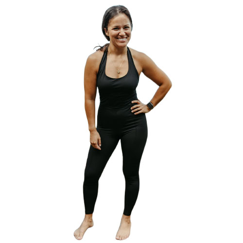 A woman wears a black, full-length athletic jumpsuit with a halter neck design, suitable for workouts or casual wear.