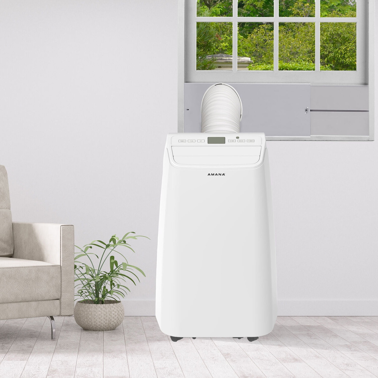 A portable Amana air conditioner with a vent hose is positioned in front of a window in a room, featuring digital controls and a modern design.