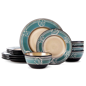 A dinnerware set featuring plates and bowls with a teal and beige color scheme and decorative sea-themed designs, including starfish and shells.