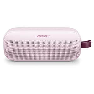 Bose portable Bluetooth speaker in light pink with a maroon carrying strap, featuring a perforated front grille and top control buttons.