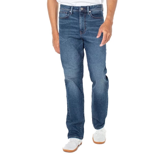 A person is wearing straight-leg blue jeans paired with white sneakers.