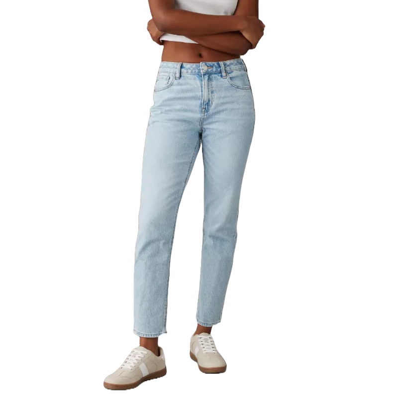 AE Strigid Mom Jean features a high-waisted, slightly relaxed fit in a light blue wash, paired with a simple white tank top and white sneakers with tan soles.