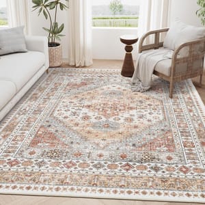 A living room with a patterned area rug featuring intricate designs in muted tones, accompanied by a sofa, a woven chair with a blanket, and a potted plant.
