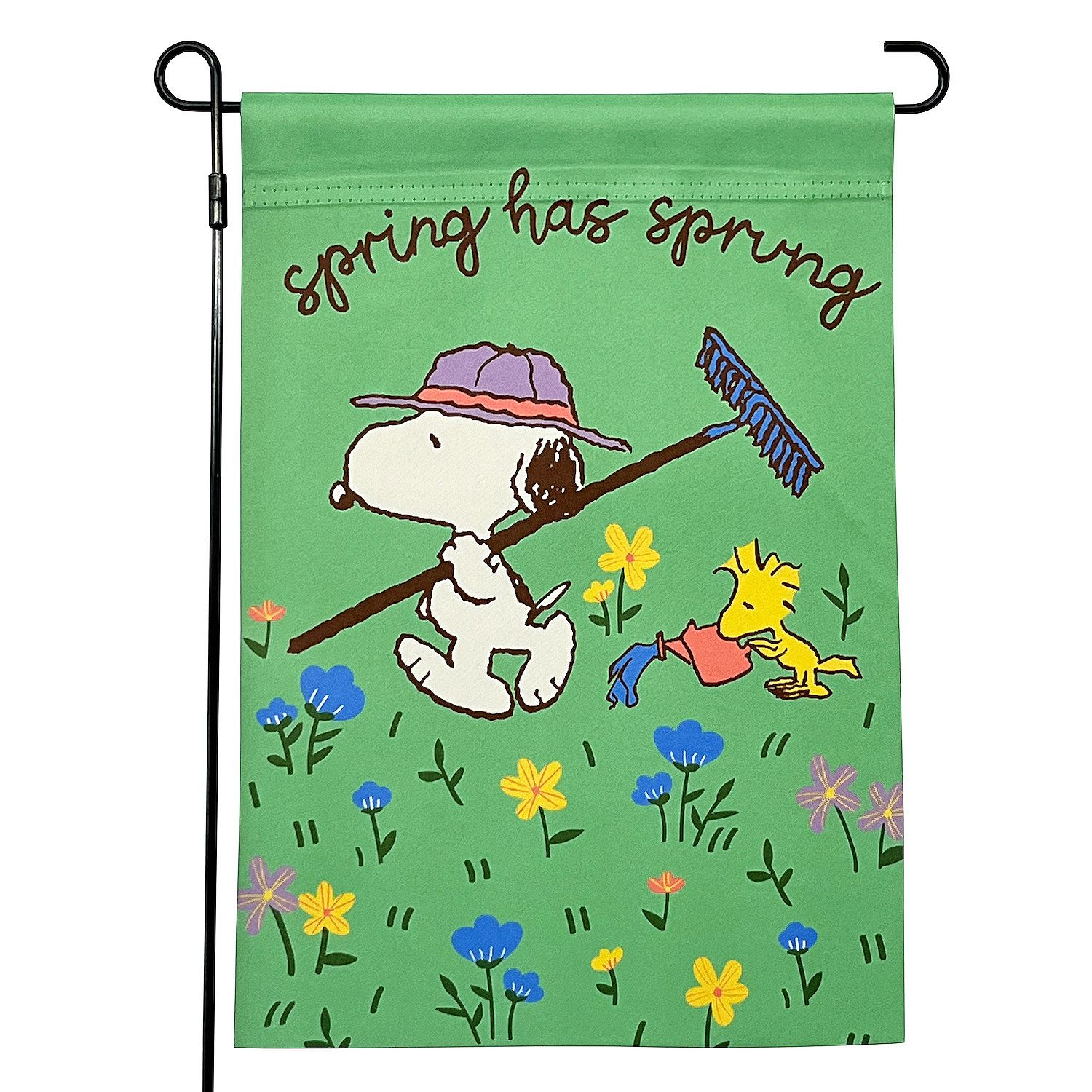 A colorful garden flag featuring cartoon characters enjoying a spring day with flowers, a rake, and a watering can, accompanied by the text \“spring has sprung.\“