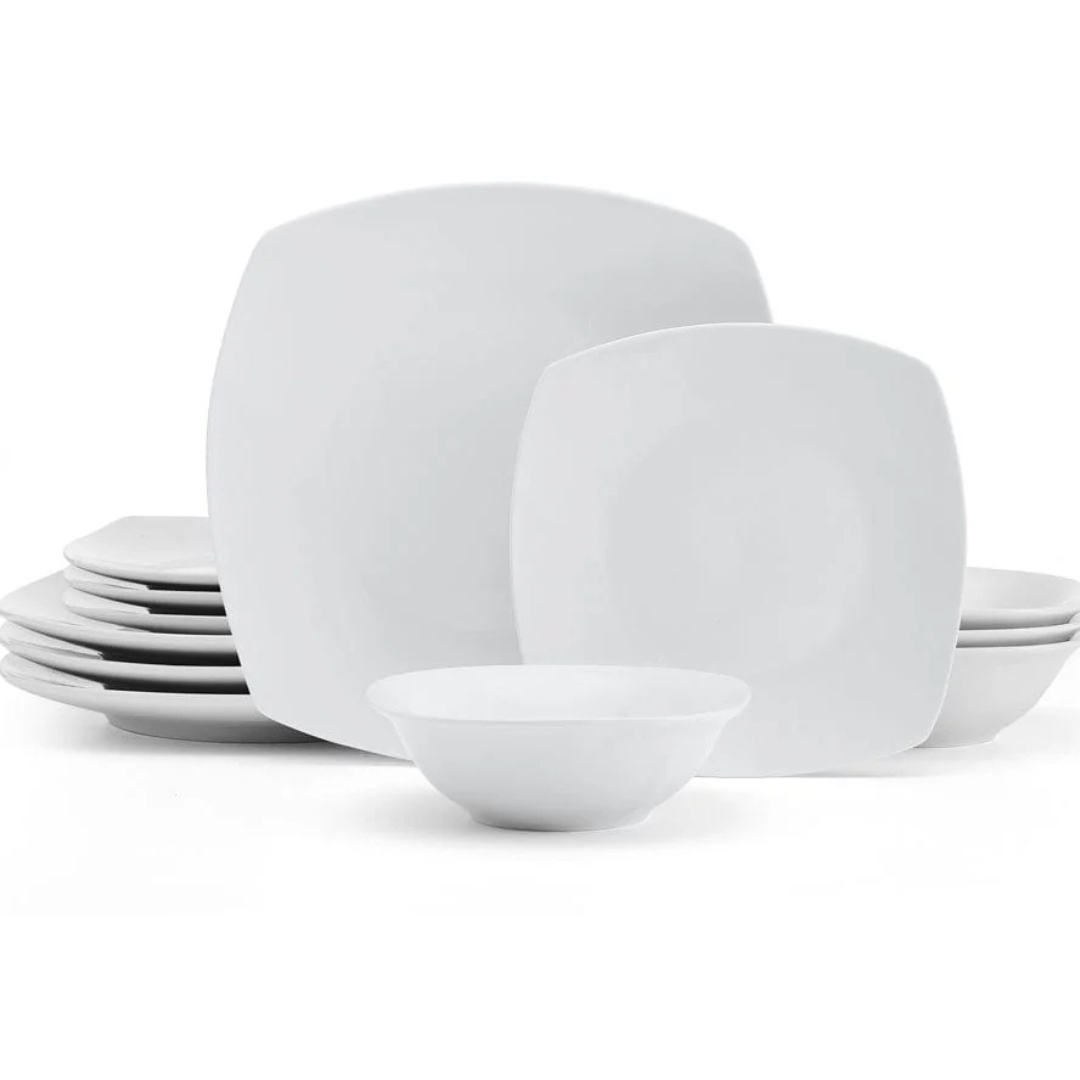 A white dinnerware set featuring square-shaped plates and round bowls, neatly stacked.