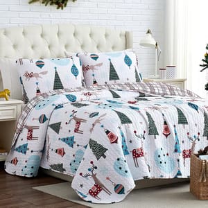 A holiday-themed quilt set with matching pillowcases, featuring Christmas trees, reindeer, and snowman patterns.