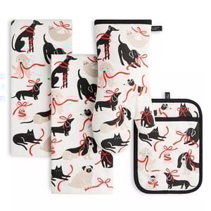 The 4-piece Kate Spade Pets Kitchen Textiles Set includes two dish towels, an oven mitt, and a pot holder. They are decorated with playful black and beige pet-themed designs featuring dogs and cats with red bows on a white background.