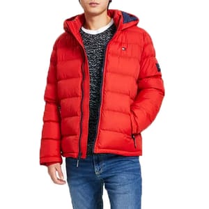 A red puffer jacket with a hood, worn over a black and white sweater, paired with blue jeans.