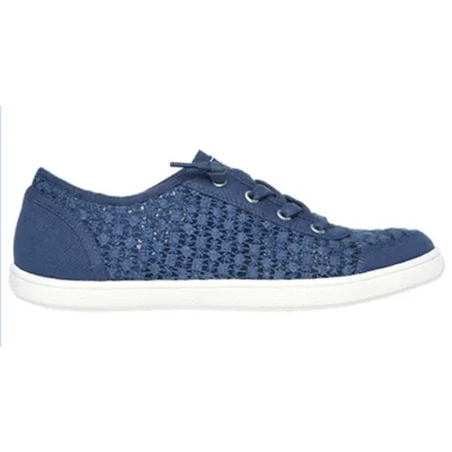The Skechers BOBS B Cute Shoes feature a blue crochet-style fabric with lace-up details and a white rubber sole, offering a casual and breathable design.