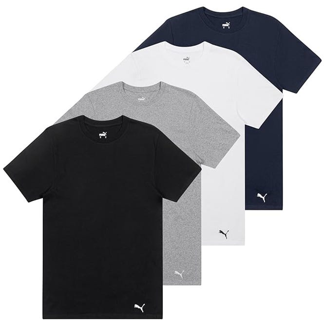A set of four Puma t-shirts in black, gray, white, and navy blue, each featuring the Puma logo on the collar and lower left.