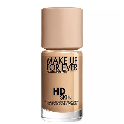Make Up For Ever HD Skin Foundation is shown in a beige bottle with a minimalist design, featuring its branding and description.