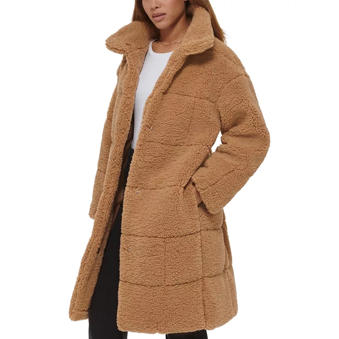 A long teddy coat in light brown features a large collar, button-down front, and distinctive horizontal paneling with a relaxed fit.