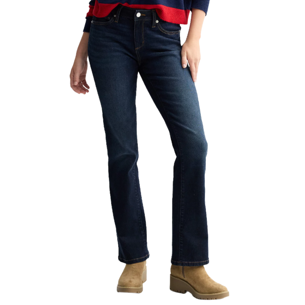 A person wearing dark blue bootcut jeans and tan suede boots, paired with a red and navy sweater.