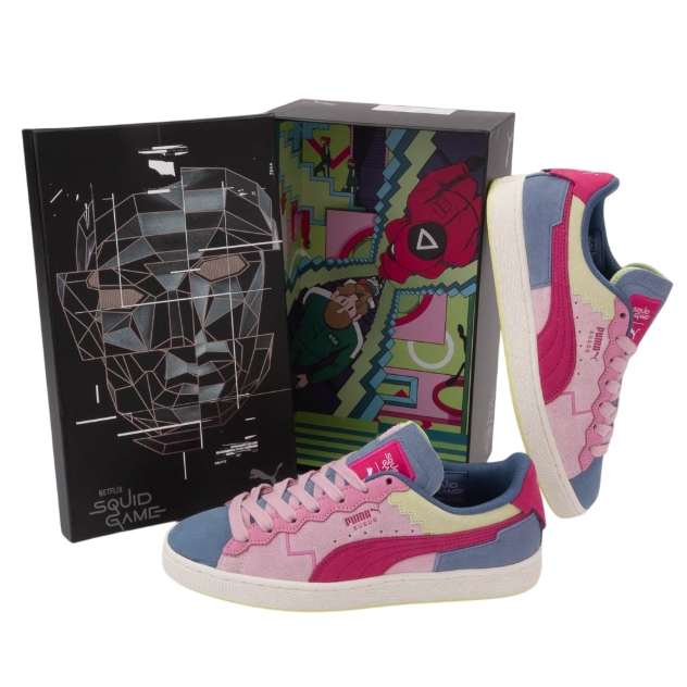 Puma x Squid Game shoes feature a colorful design with pink, blue, and yellow suede panels, and the Puma logo on the side. They come with a themed box displaying Squid Game graphics and branding.