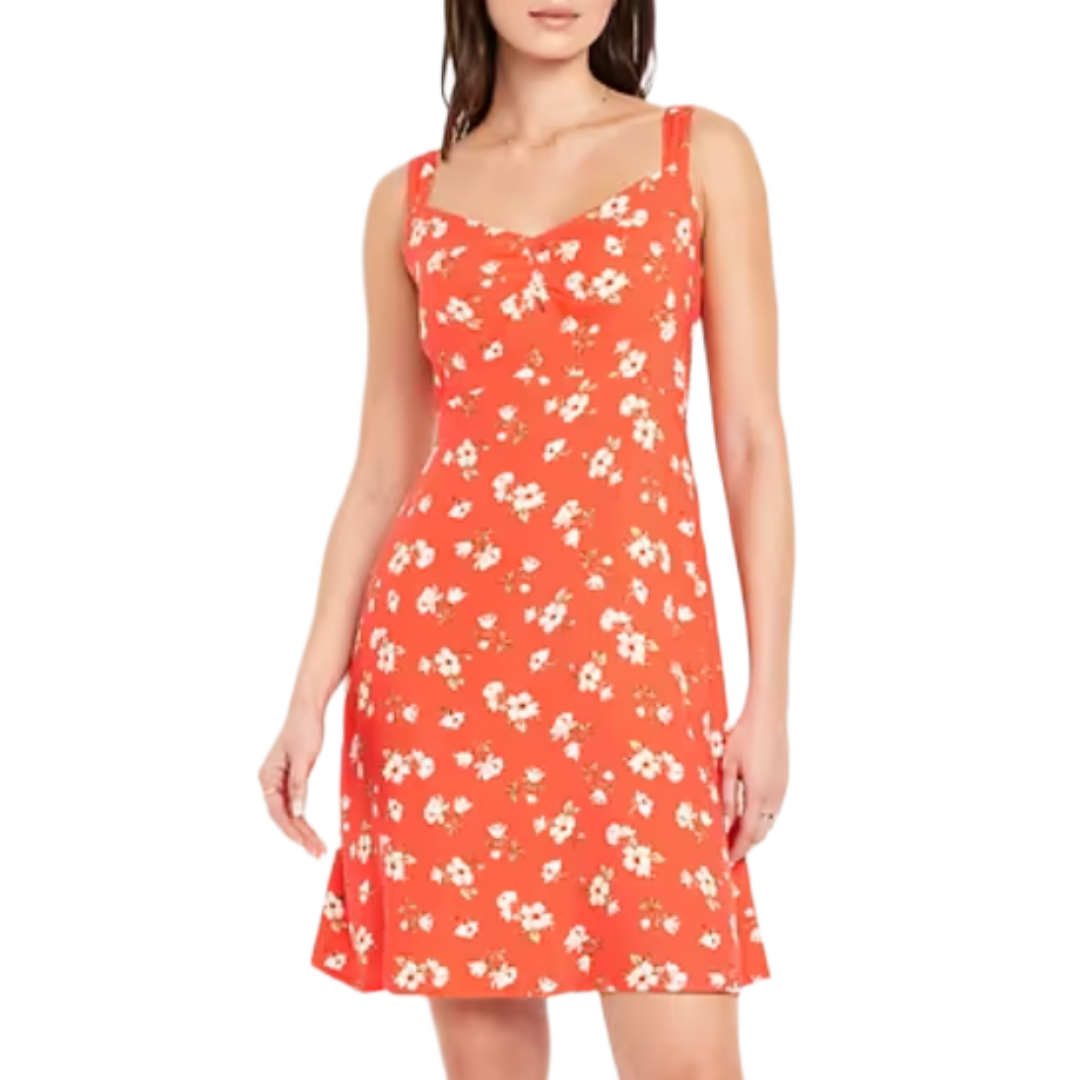A sleeveless red dress featuring a white floral print, fitted bodice, and A-line skirt.