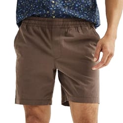 A person is wearing brown shorts with an elastic waistband and side pockets, paired with a blue floral shirt.