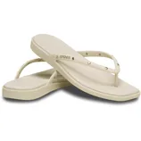 Pair of beige Crocs flip-flops with decorative studs and a simple strap design.