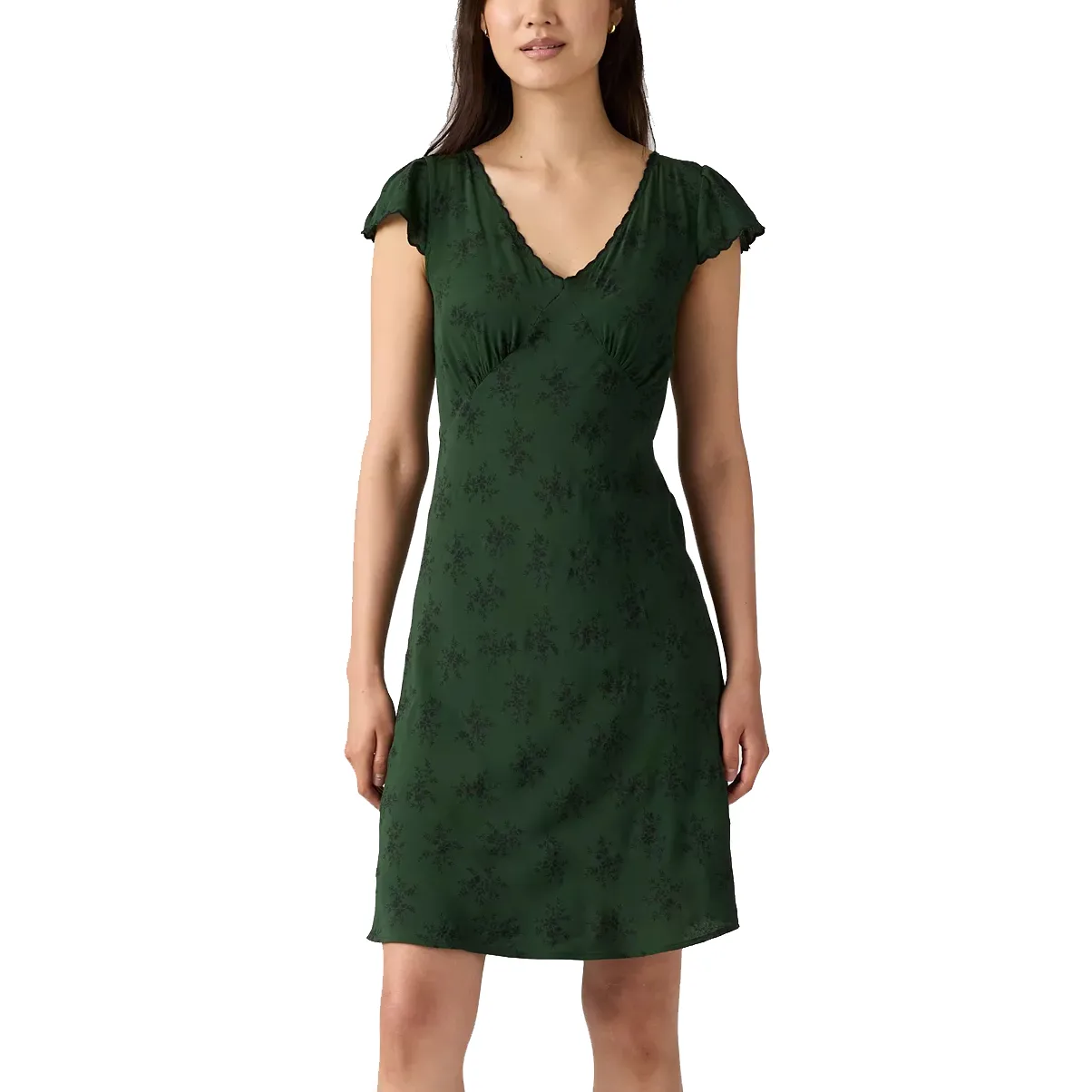 A green, short-sleeved dress with a V-neckline and subtle floral pattern, worn by a woman.