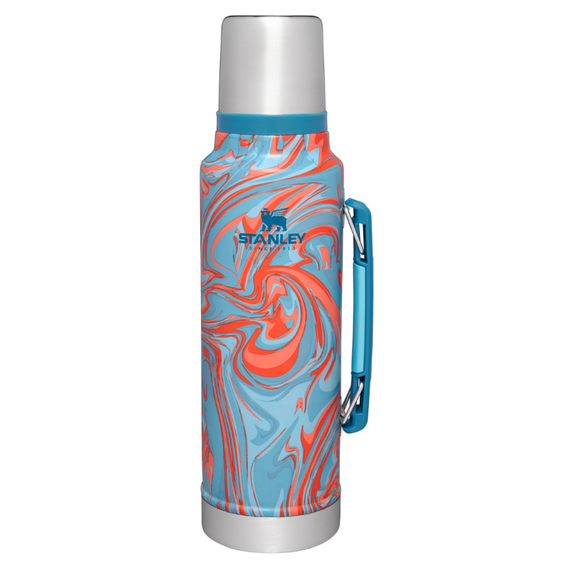 Stanley Classic Legendary Bottle with a vibrant orange and blue swirl design, featuring a silver cap, teal handle, and durable stainless steel construction for hot and cold beverages.