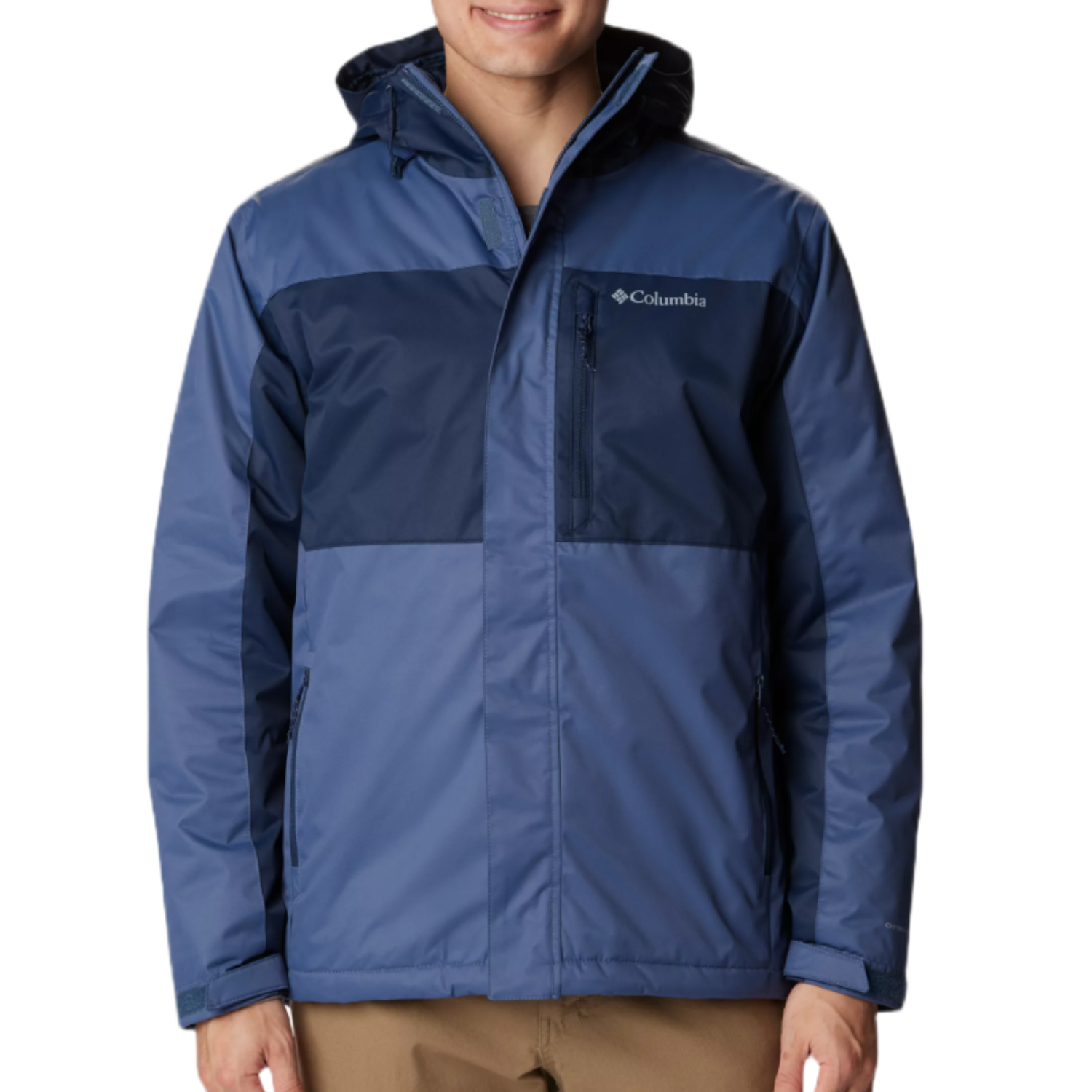 A man is wearing a Columbia Tipton Peak Insulated Jacket, which is color-blocked with navy and light blue, features a hood, and displays the brand's logo on the chest.