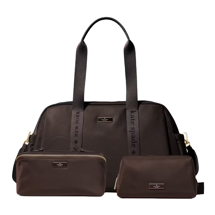 A set of three dark brown bags, including a large tote with \“Kate Spade New York\“ straps and two smaller accessory pouches with logo plaques.